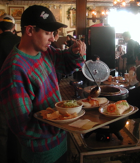 Serving green chile stew from the steaming cauldron. Serving green chile stew from the steaming cauldron.