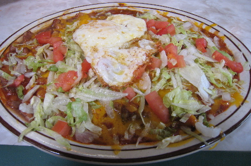Blue corn tortilla enchiladas topped with a fried egg