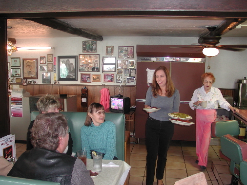 The beauteous Antoinette serves happy patrons.  Mary walks behind her