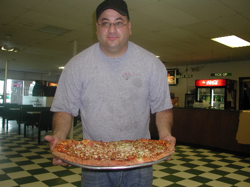 Carl Garcia and his vivacious sister Cathy run the 98th Street Restaurant.  A 20" pizza is destined for the table of a lucky diner.