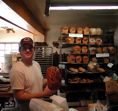 Number one son Chris Morales displays the Panaderia's specialty, green chile bread hot off the oven.