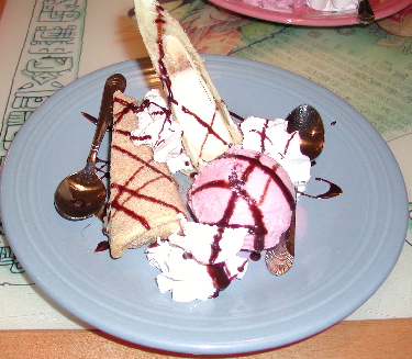 This rich dessert features strawberry ice cream and a banana cheesecake chimichanga drizzled with chocolate.