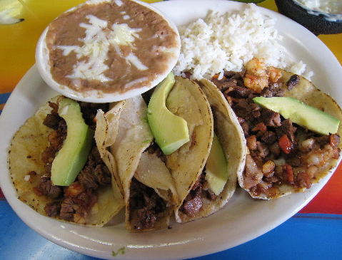 Four Tacos Al Patron: flour tortillas engorged with beef, bacon, peppers and more.