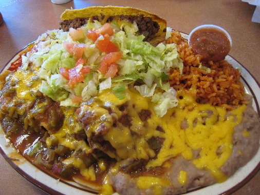 Combination plate: cheese enchilada, taco, tamale and chile relleno with Spanish rice and refried beans