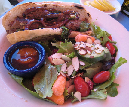 Sliced sirloin steak with baby spinach, red onion and Stilton blue cheese in a toasted hoagie roll