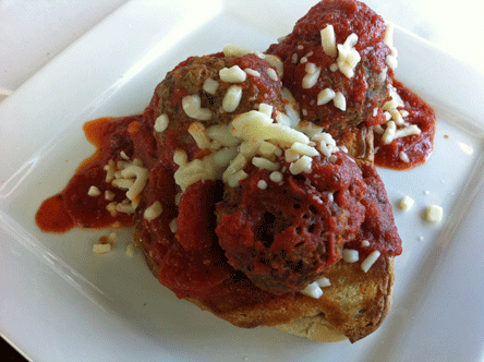 Panini Marinara with Meatballs: An open-faced, mozzarella-stuffed garlic bruscetta panini topped with four Italian meatballs and marinara sauce