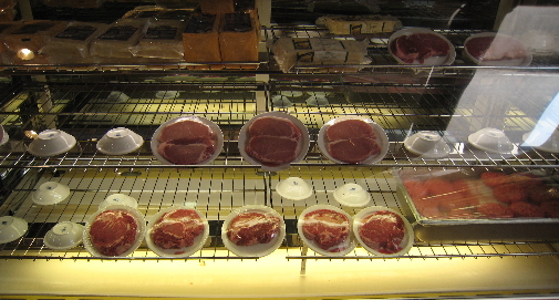 Steaks and burgers under glass