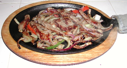 Mucho Gusto's fajitas sizzle with flavor