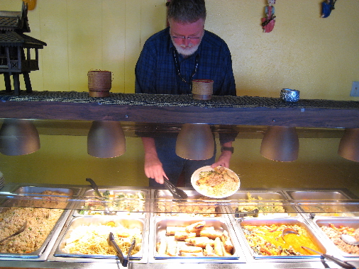 Bill Resnik fills his plate for the fourth time on Tawan's buffet