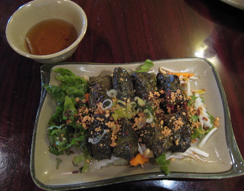 Grilled beef wrapped in grape leaves