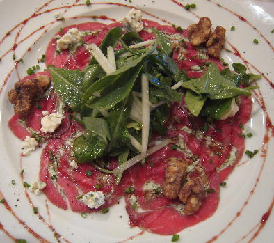Arugala and Granny Smith apple salad with dry-aged carpaccio beef, Maytag Blue Cheese, candied walnuts and port wine drizzles